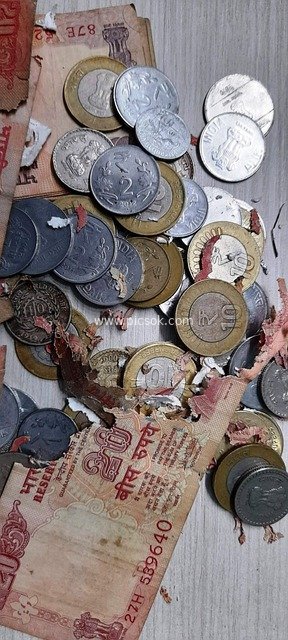 Financial Currency Scene with Damaged Banknotes and Scattered Coins