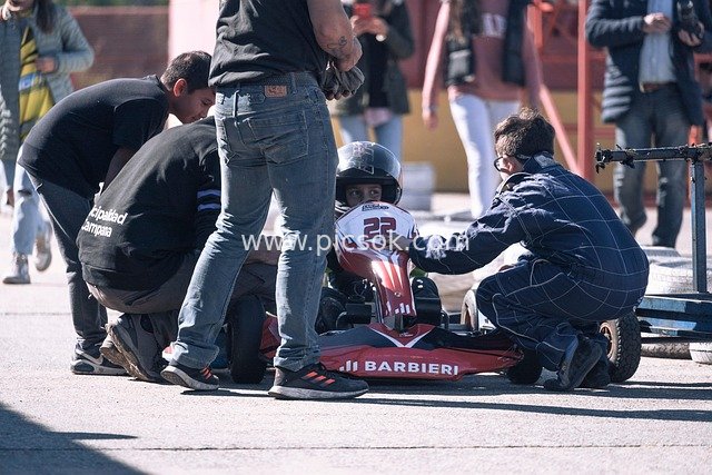 Kart Race Preparation: Team Assists Driver in Tuning the Kart
