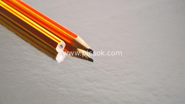 Two Colored Pencils with Desktop Reflection – Close-Up of Study & Office Stationery