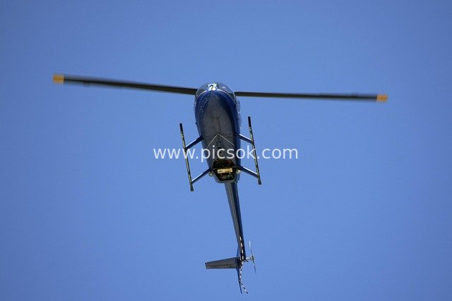 Blue Helicopter Flying in the Blue Sky - Aerial Sightseeing Scene