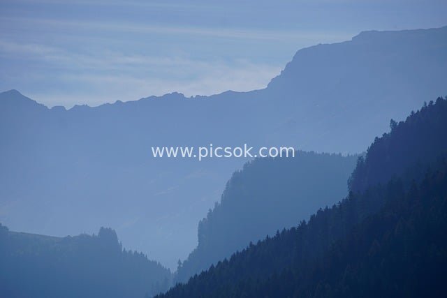 Layered Alpine Mountain Landscape Shrouded in Mist