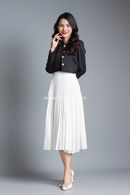 Photo of a Smiling Professional Woman in Fashionable Business Attire