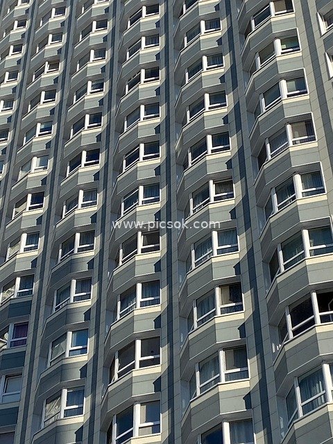 Modern High-Rise Apartment Building with Geometric Balconies and Windows