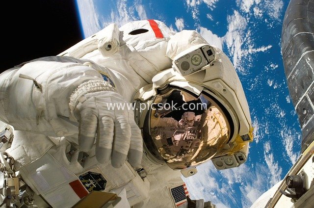 Close-up of NASA Astronaut's Spacesuit Against Earth Background During Space Mission