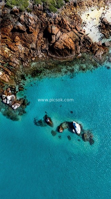 Aerial View of Western Australia's Coast: Turquoise Waters, Red Rocks, and White Sandy Shores