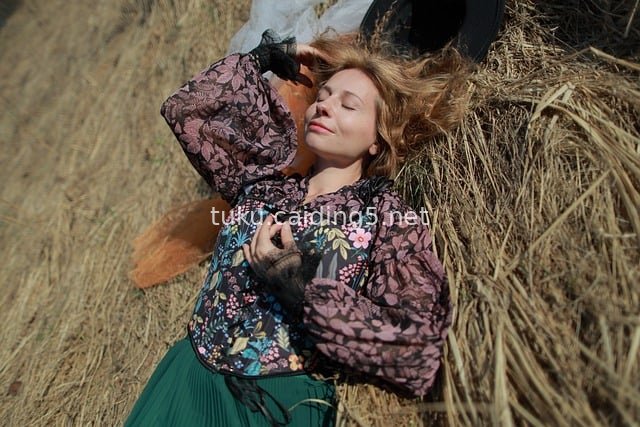 Bohemian Style Fashion Portrait of a Woman in a Sunlit Haystack