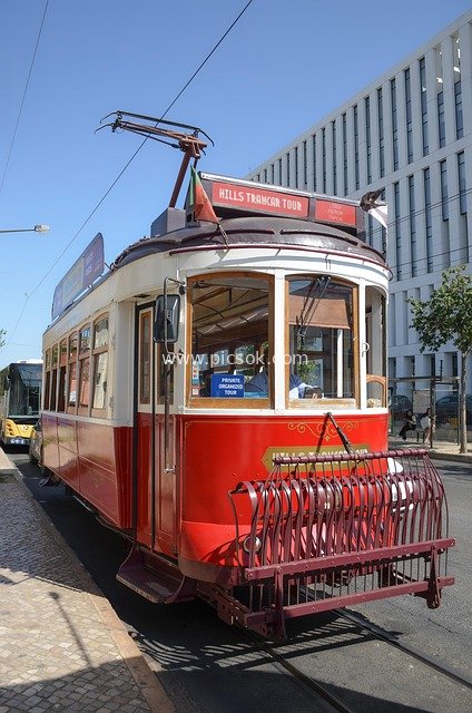 Vintage Red Sightseeing Tram: Urban Tourist Transportation Scene