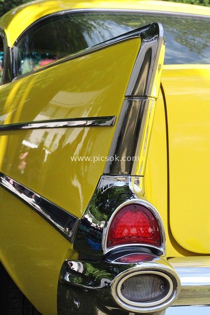 Close-up of the Rear End of a Bright Yellow 1957 Chevrolet Bel Air Classic Car