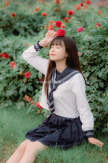Fresh Portrait of a Teen Girl in Sailor Suit on Flowery Grassland