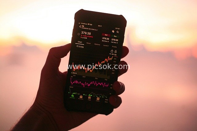 Checking Stock Market on Phone at Dusk - Financial Investment & Tech Scene