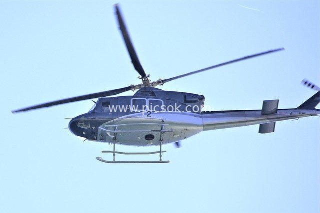 Helicopter Flying in the Blue Sky – Aviation Scene with Rotating Rotors
