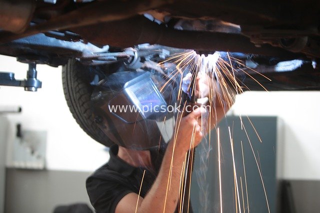 Welding in an Auto Repair Workshop: A Spark-Filled Auto Maintenance Scene