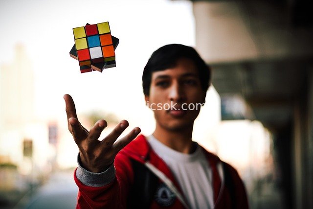 Creative Childhood Moment of a Street Teen with a Levitating Rubik's Cube