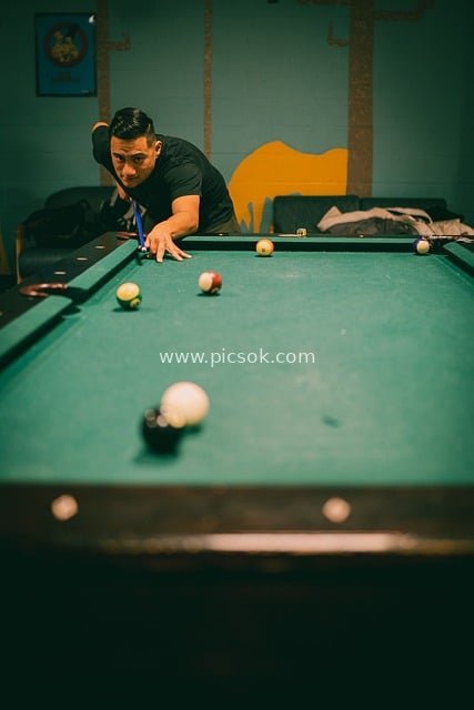 Man Focused on Playing 8-Ball in a Billiards Room - A Leisure Scene