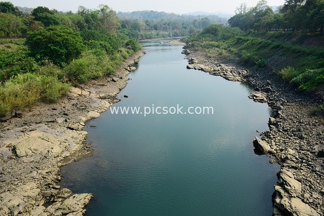 Mountain Wilderness Natural Landscape with Winding River and Rocky Banks