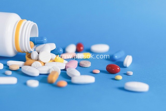 Colorful Pills & Capsules Spilled from Medicine Bottle - Healthcare Pharmaceutical Stock Image
