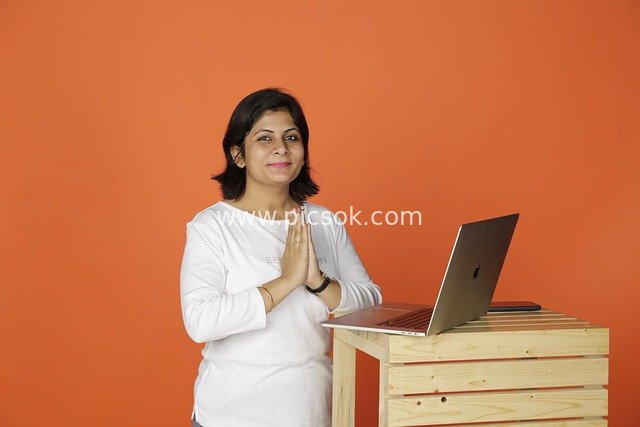 Smiling Professional Woman Working on Laptop in Business Office Scene