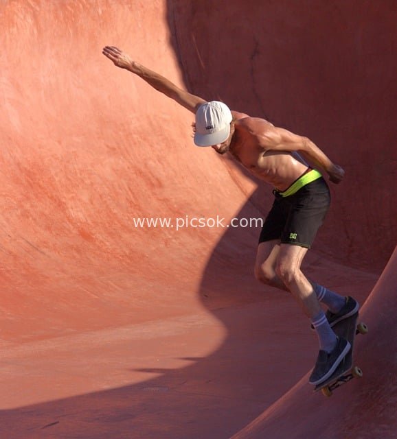 Shirtless Man Nails Cool Jump at Skate Park – Dynamic Skateboarding Moment Captured