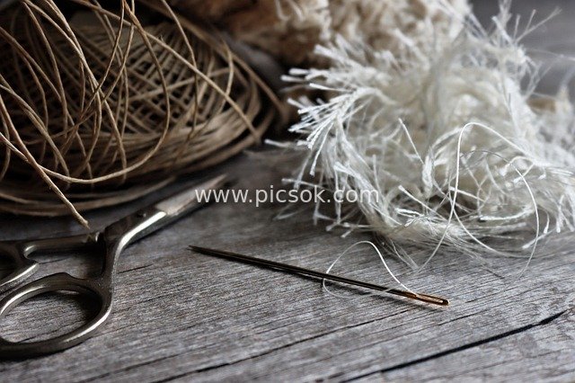 Nostalgic Wooden Table Scene with Vintage Handmade Sewing Tools and Hemp Rope