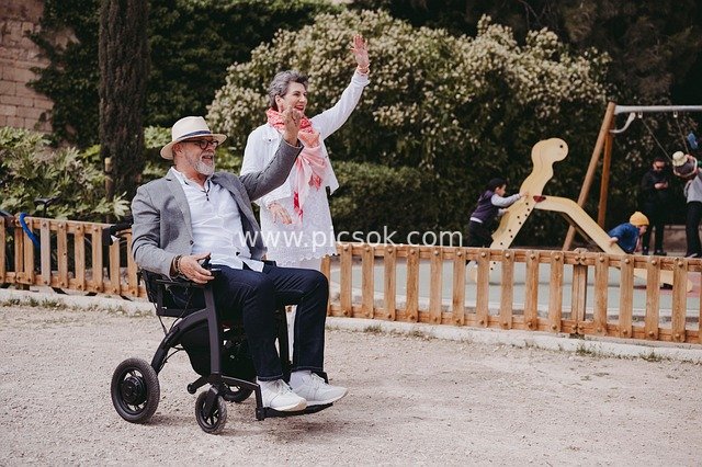 Heartwarming Daily Scene of an Elderly Couple Enjoying Leisure in the Park with Wheelchair Access