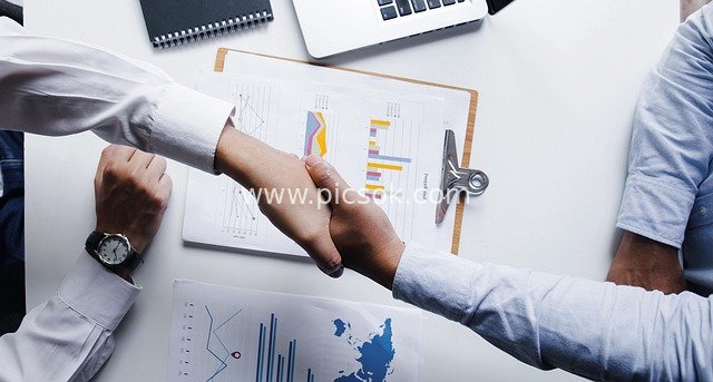 Business Handshake Sealing Cooperation Agreement: Win-Win Scenario for Workplace Teams