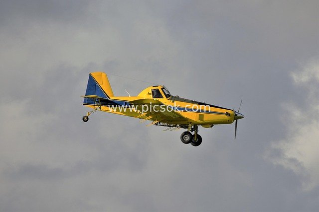 Yellow Aerobatic Plane in Flight – Four-Bladed Propeller Aircraft Material