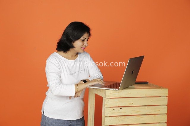 Business Scene of a Professional Woman Focused on Working with a Laptop