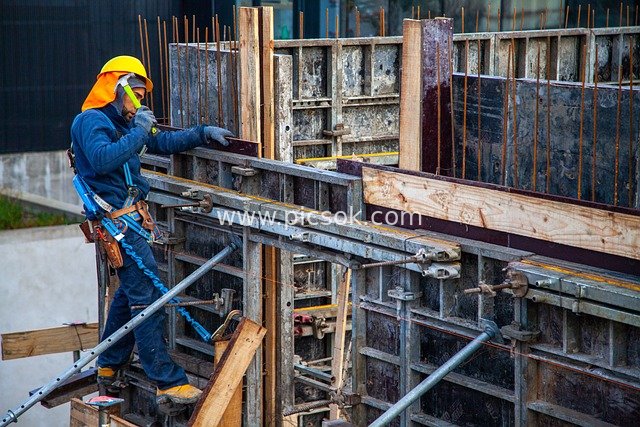 Construction Worker Operating at Construction Site with Standard Safety Protection