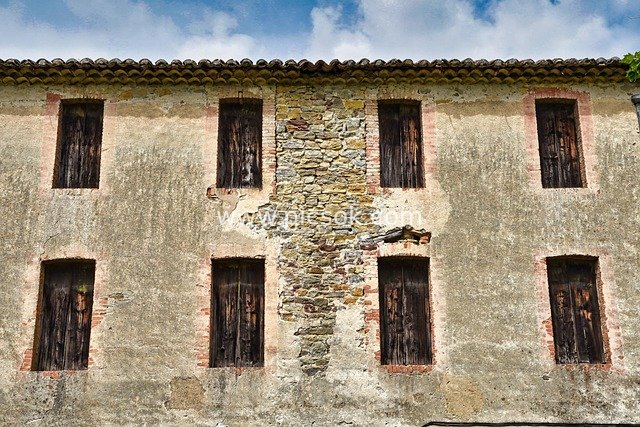 Weathered Walls and Wooden Shutters of an Abandoned Rural Building