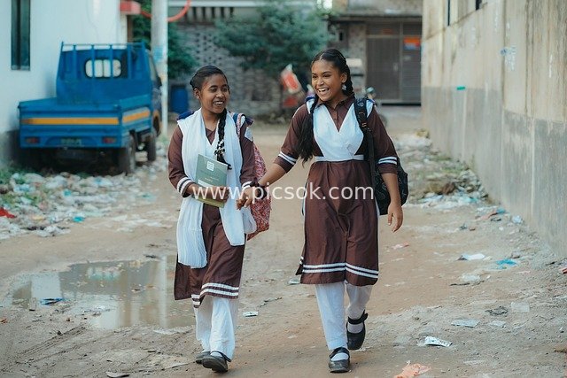 Bangladeshi Schoolgirls Smile on Way to School, Uniformed Girls Walking Together on Street
