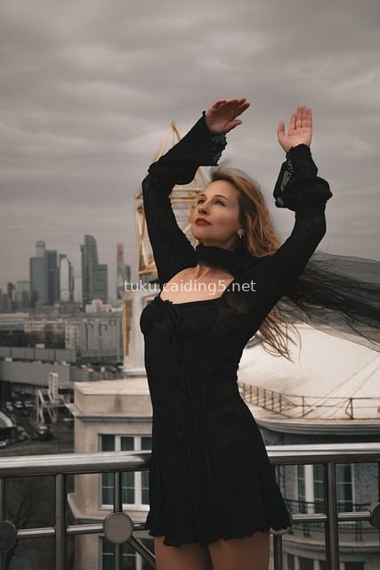 Gothic-Style Woman Portrait on Rooftop with City Skyline Background