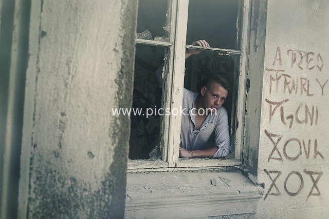 Man at the Window of an Abandoned Building – Graffiti & Urban Ruins Scene