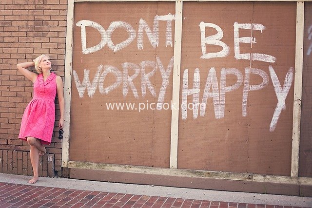 Joyful Moment: Woman in Pink Dress & Inspirational Graffiti Wall