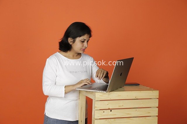 Business Scene of a Professional Woman Focused on Working with a Laptop