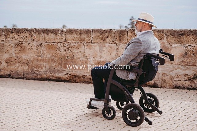 Stylish Elderly Man Enjoying Outdoor Leisure on a Modern Electric Wheelchair