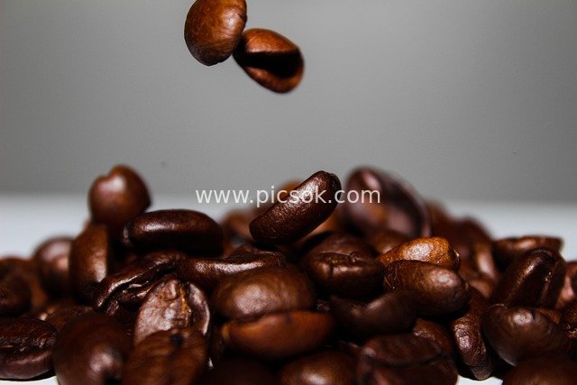 Close-up of Piled Coffee Beans and Slow-Motion Falling Ones
