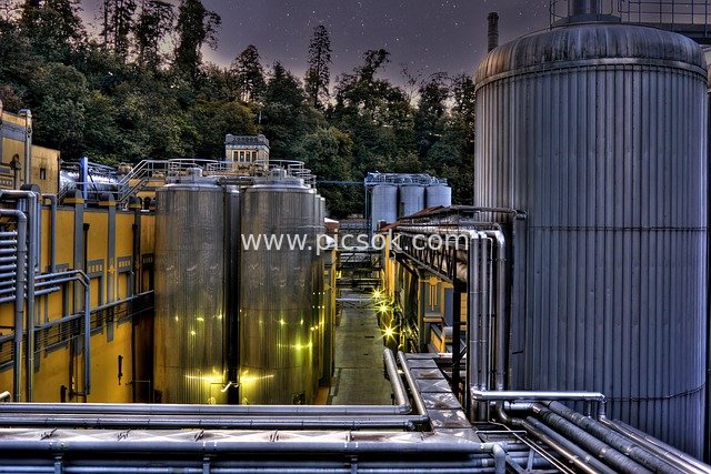 Brewery Industrial Scene at Dawn: Metal Tanks and Piping Equipment