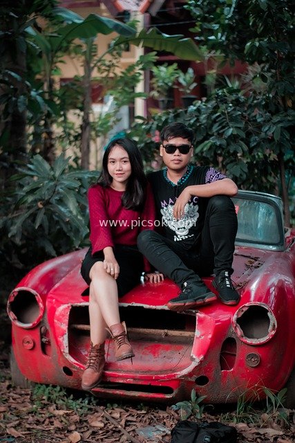 Young Couple in a Vintage Red Convertible: Romantic Outdoor Love Scene