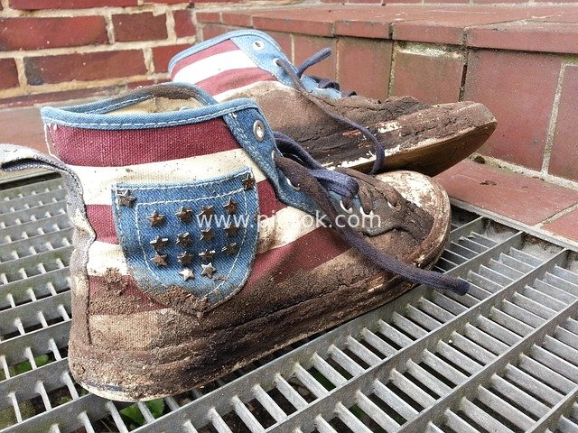 Old US Flag Sneakers Caked in Mud – Traces Post-Hurricane and Festival