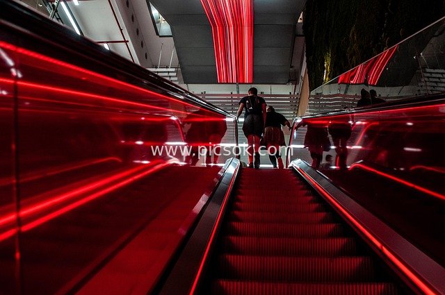 Escalator with Red Lighting in Modern Building Interior