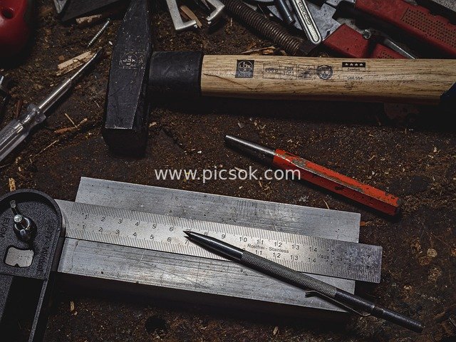 Scattered Professional Tools in Workshop: Hammers, Rulers, and Mechanical Tools