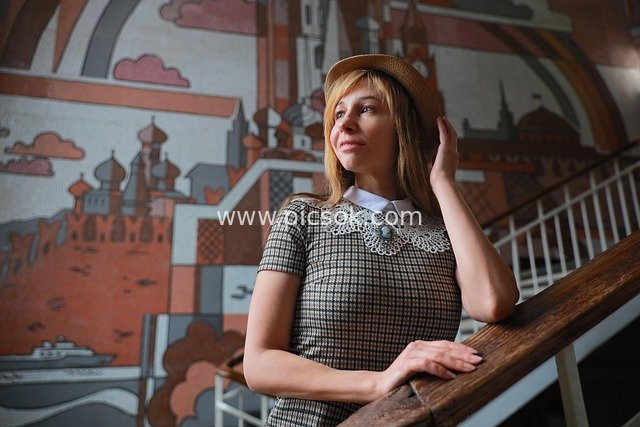 Portrait of a Woman in Vintage Attire on Stairs Before Moscow Kremlin Mosaic