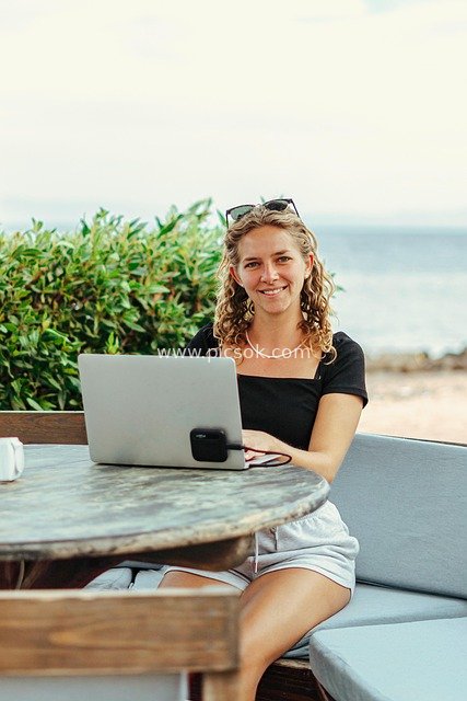 Female Digital Nomad Working Online by the Beach