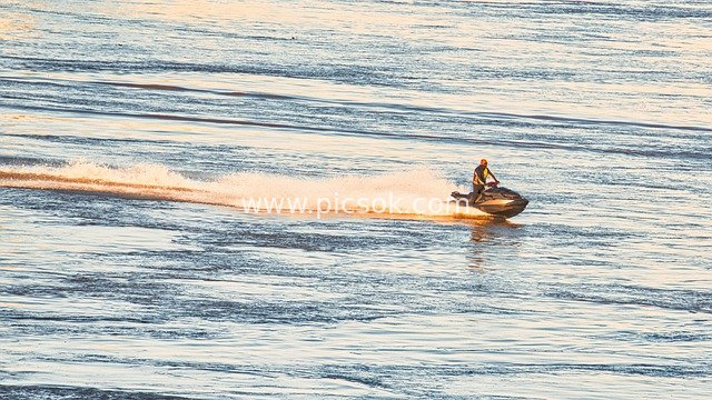Dynamic Scene of a Man Riding a Jet Ski Across the Water at Sunset