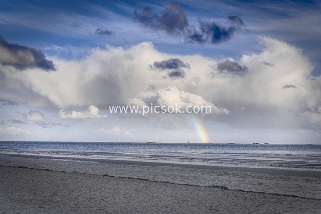 Rainbow Over Beihai Beach with Majestic Cloudy Seascape