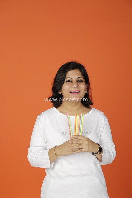 Creative Office Moment of a Smiling Professional Woman Holding Colorful Straws