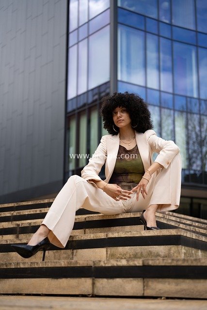 High - Fashion Portrait with Artistic Pose in Front of Modern Architecture