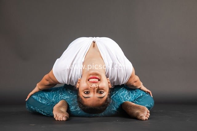 Female Yoga Practitioner Demonstrates Flexible Poses Indoors with Yoga Mat Support