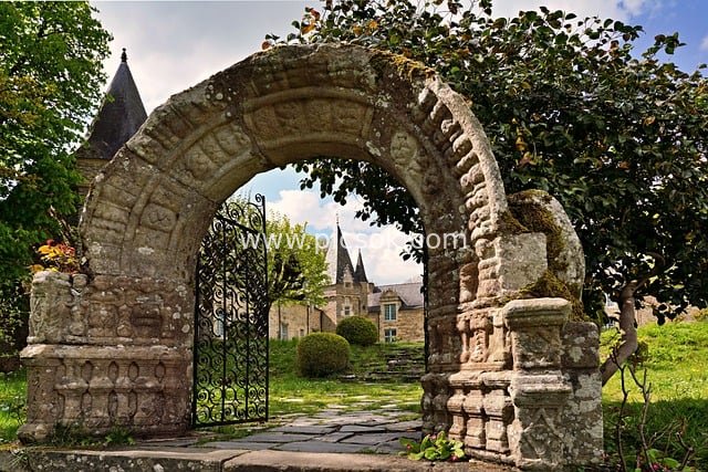Scenic Photo of Ancient Stone Arch and European Manor Architecture