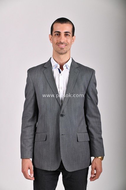 Businessman in Gray Suit Showcasing Workplace Success Image